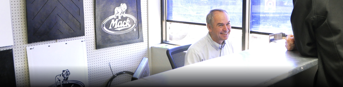 Mack parts with smiling man behind counter